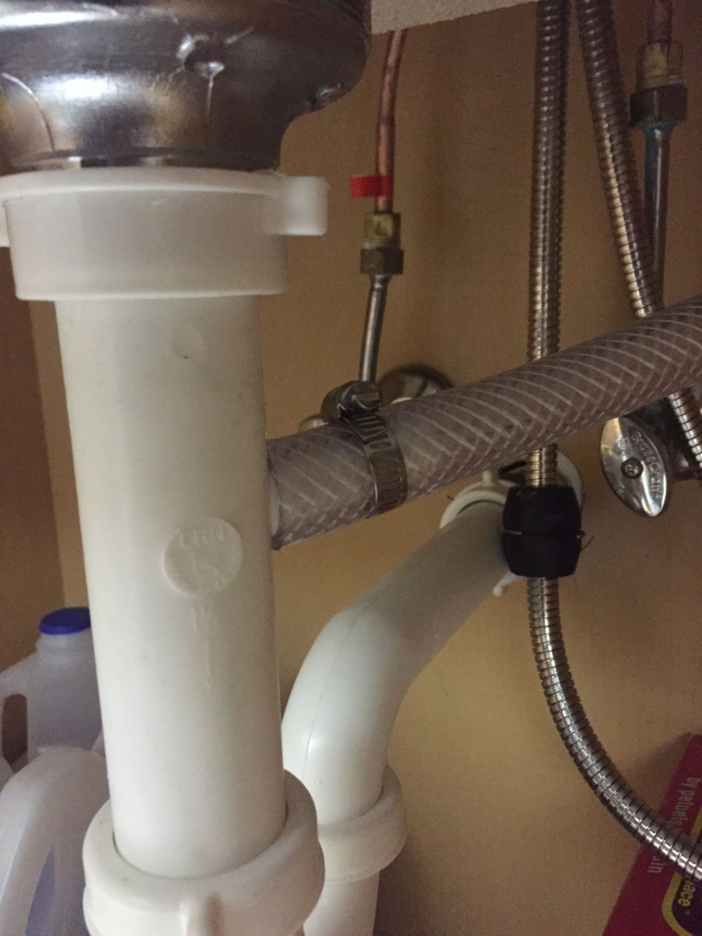 Clamping the drain hose to the drain under the sink