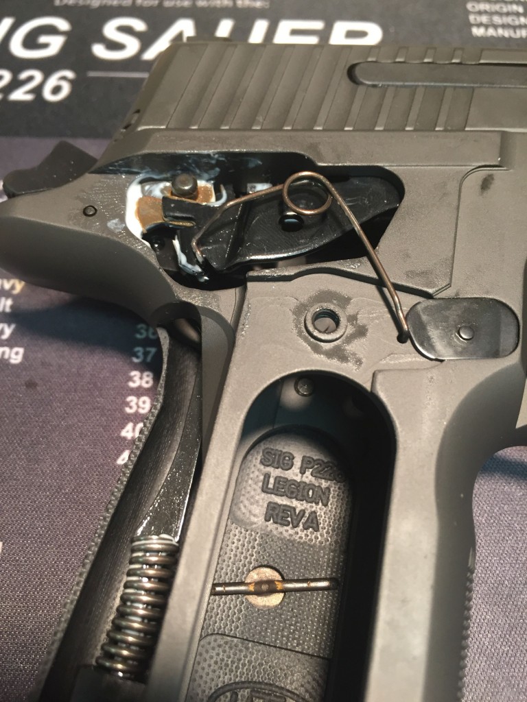 Looped trigger bar spring in a modern P226