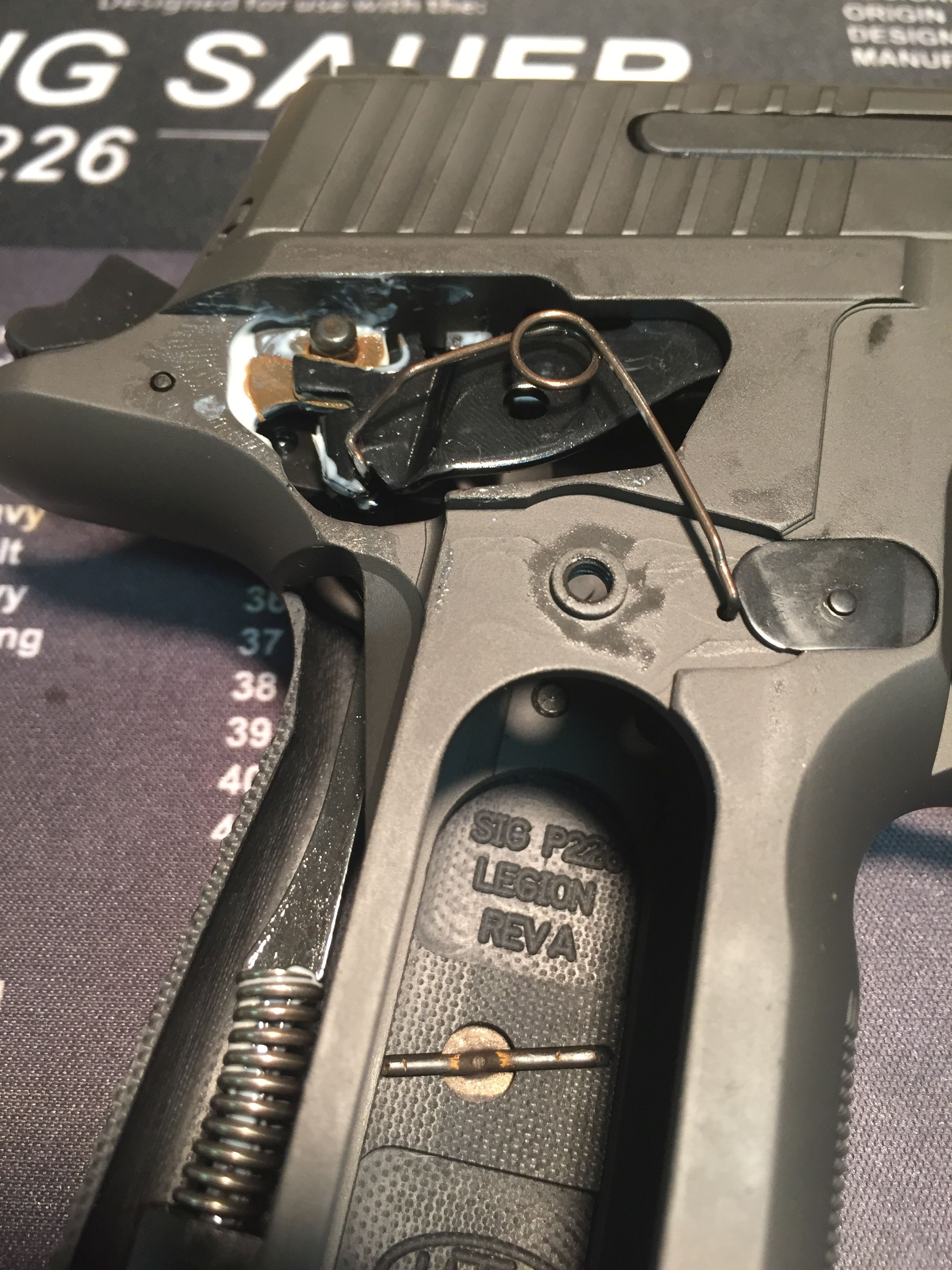 Looped trigger bar spring in modern P226s, including the Legion